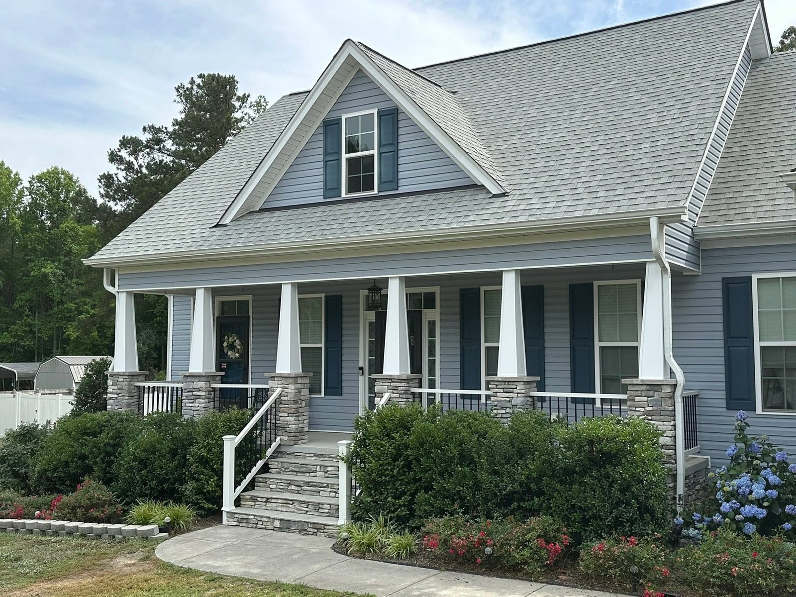 Covered porch with new railing and stone pillars